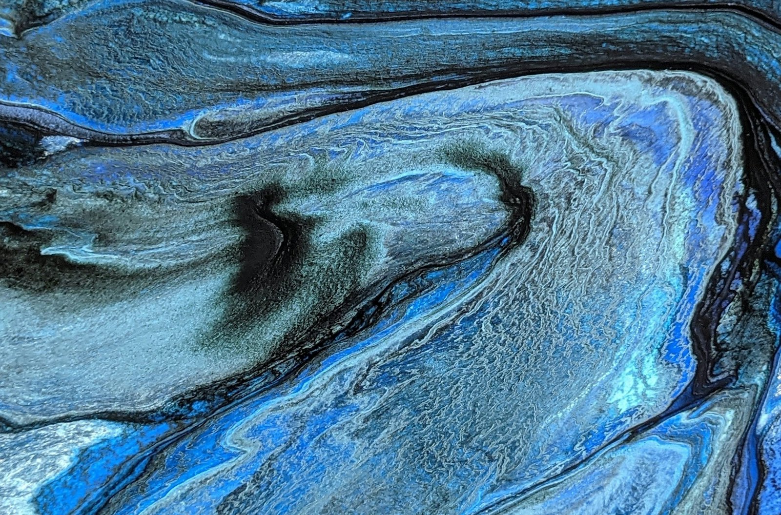 Blue, silver and black marbled pattern like a metallic epoxy floor