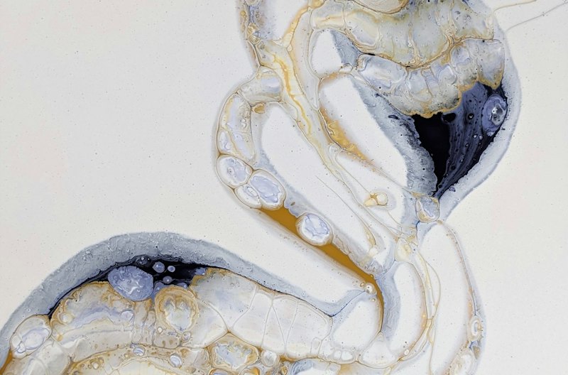 Close-up of white, silver and gold swirls like a metallic epoxy pour